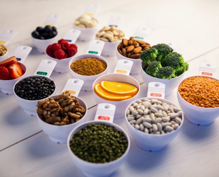 Portion cups of healthy ingredients on wooden table